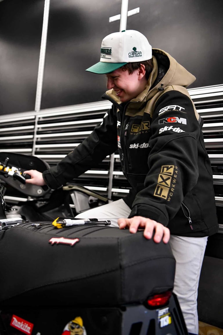 Nolan Scofeild owner working on snowmobile
